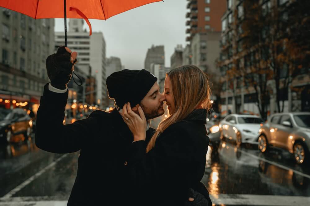 physical touch love language woman in black jacket holding red umbrella during daytime