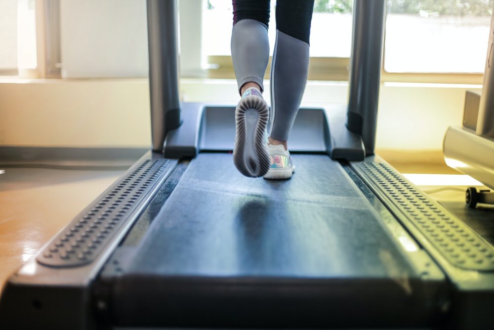 folding treadmill Photo Of Person Using Treadmill
