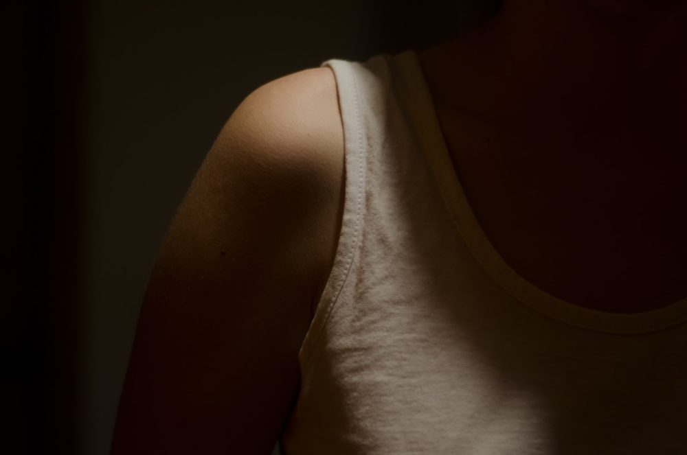 shoulder exercises person wearing white tank top